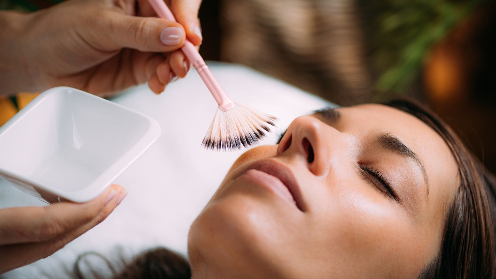 Aesthetician applies skincare during a facial treatment at Towson Med Spa.