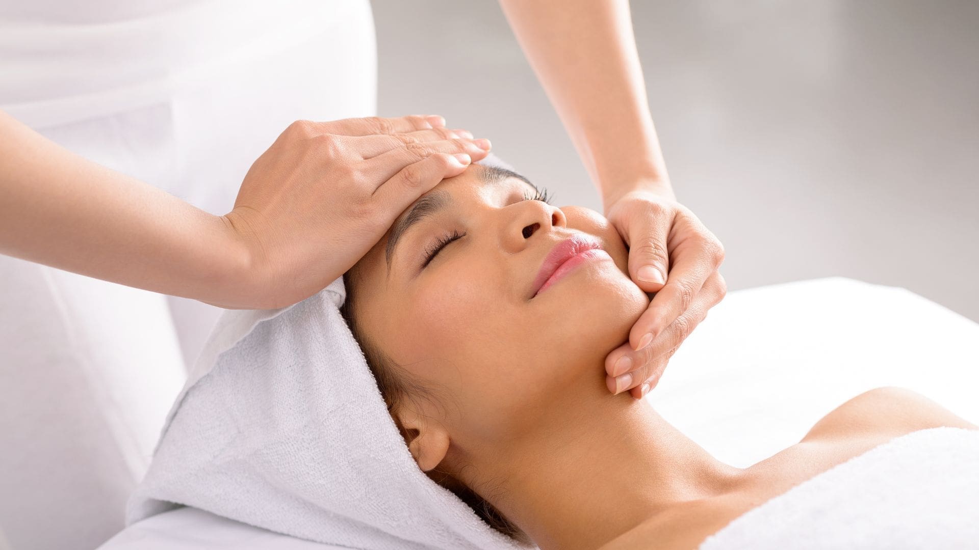 Woman receiving a chemical peel treatment with a focused facial massage, promoting skin rejuvenation and improved texture at Body Scientific Aesthetics in Towson, MD.