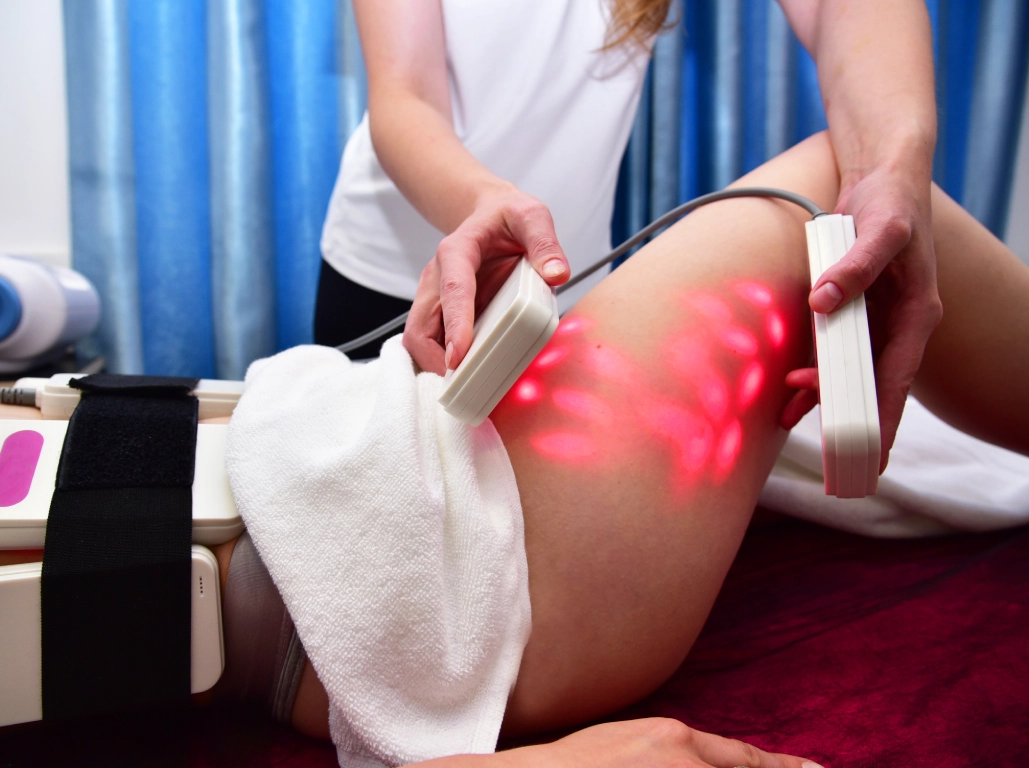 Therapeutic red light treatment on a person's thigh.