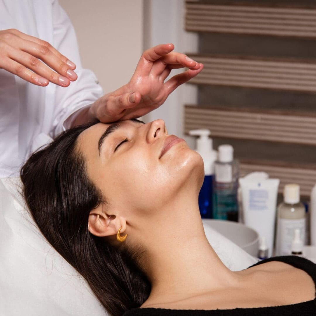 Woman enjoying a facial treatment at a spa.
