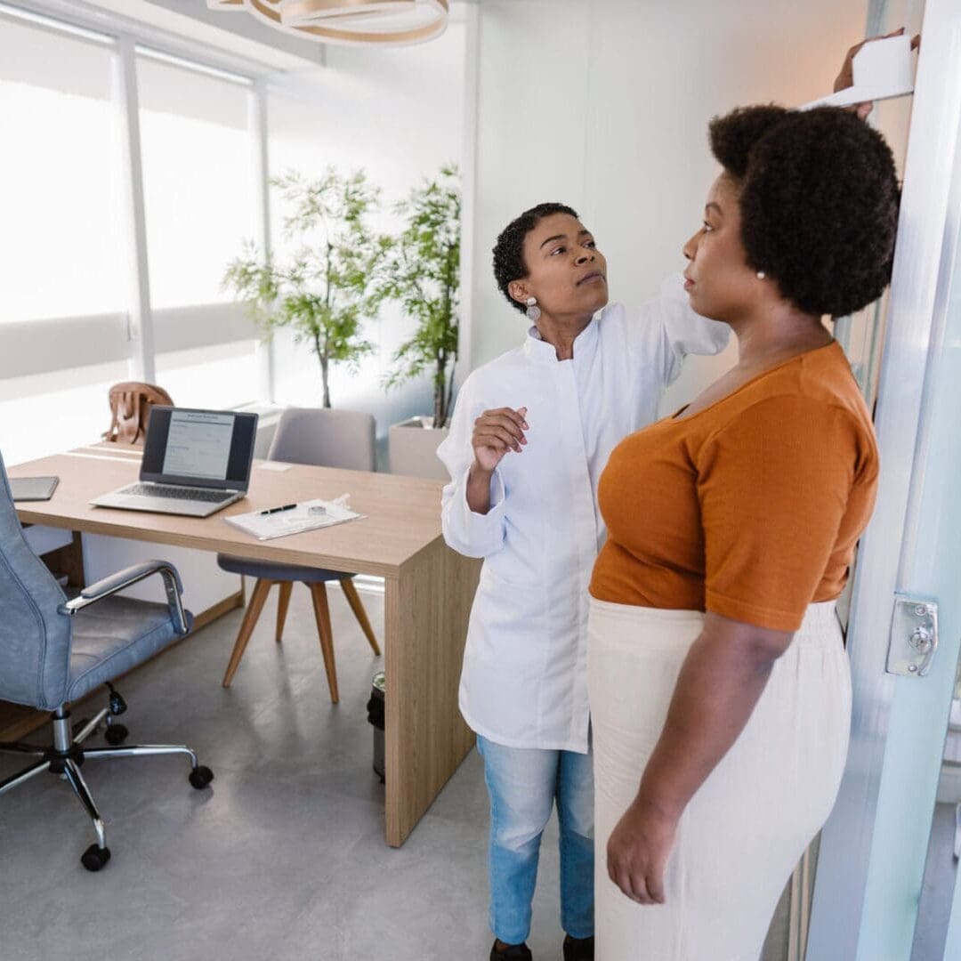 Healthcare professional consulting a pregnant woman in a clinic.