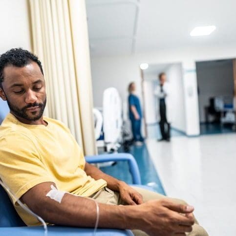 Man donating blood in a medical facility.