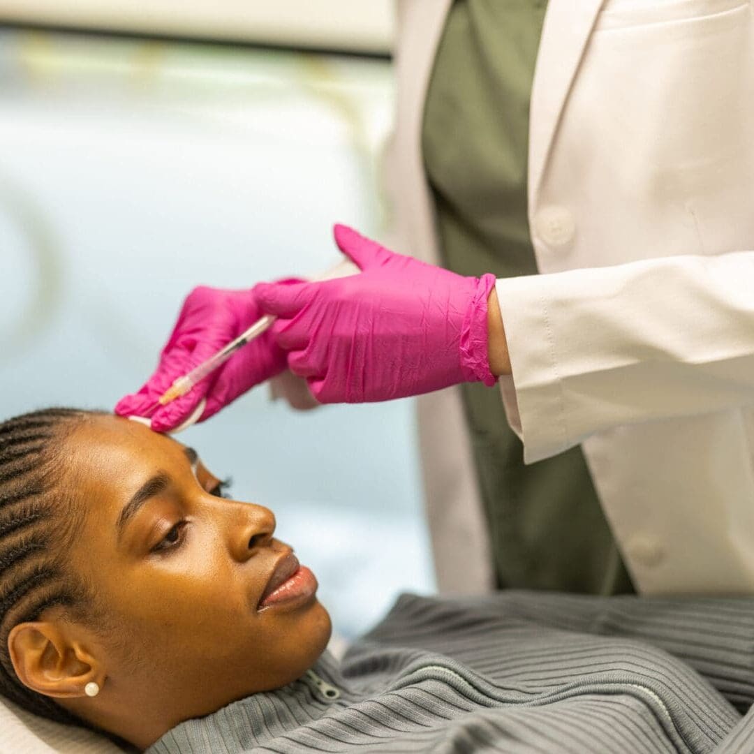 A woman receiving a cosmetic facial injection from a professional.