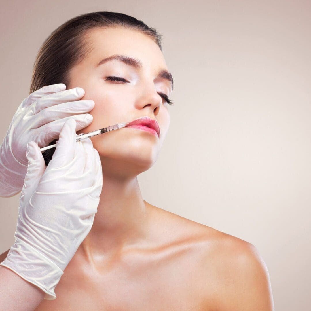 A woman receives a cosmetic facial injection.