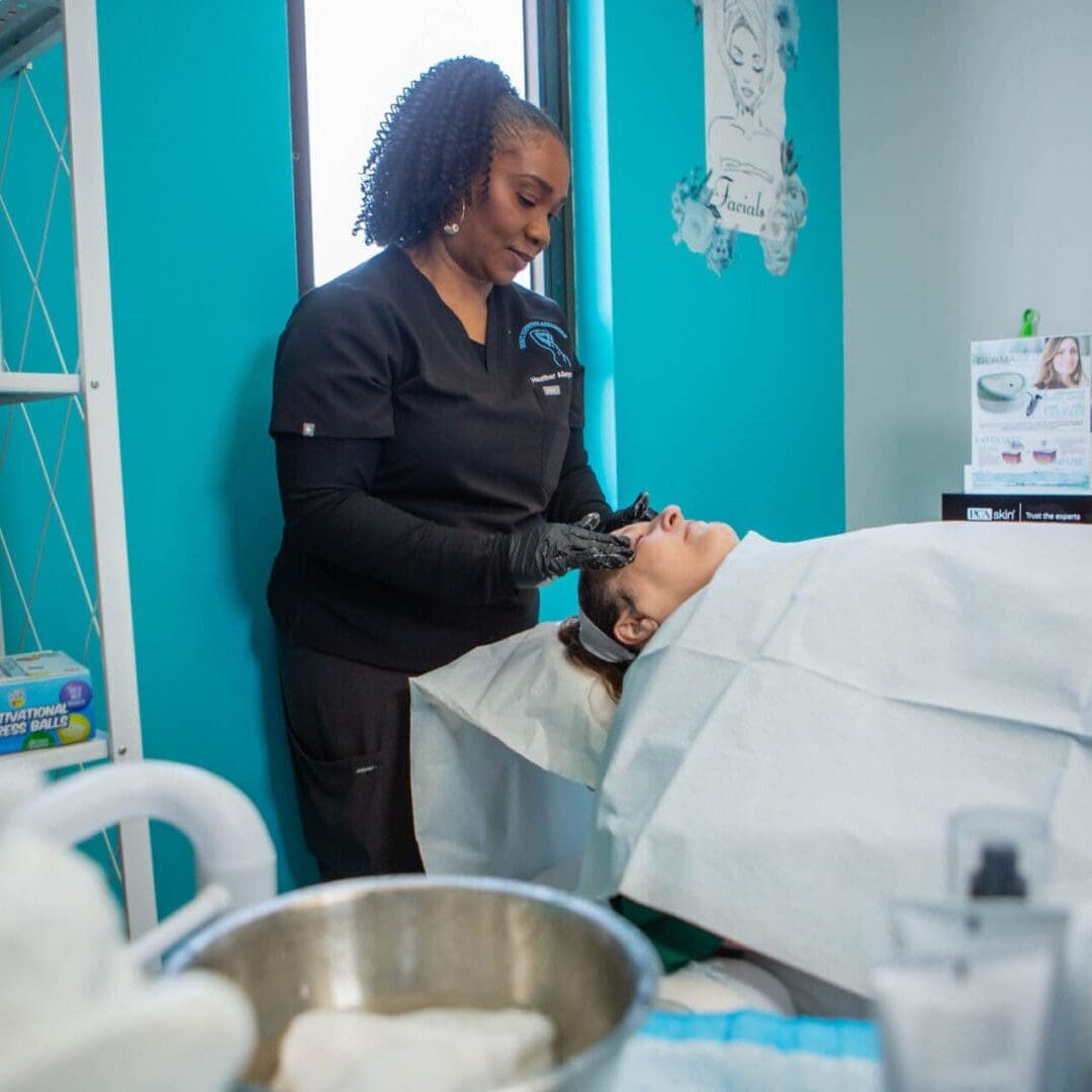 A beautician washing a client's hair in a salon.