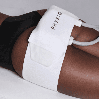 A person receiving a body contouring treatment with a PHI510 device on their thigh.