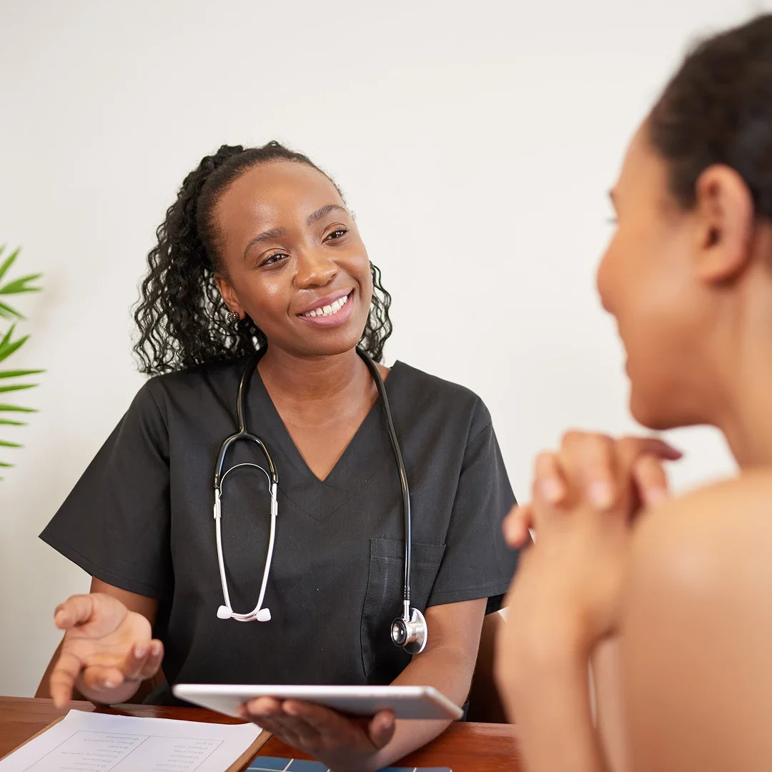 A healthcare professional attentively listening to a patient.